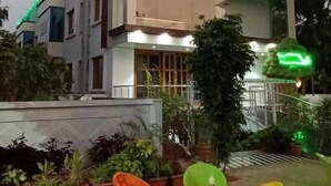 A modern building with a sign for 'A & C Deluxe Rooms'. - HOTEL GREENLAND INN HAMPI (Hospet)