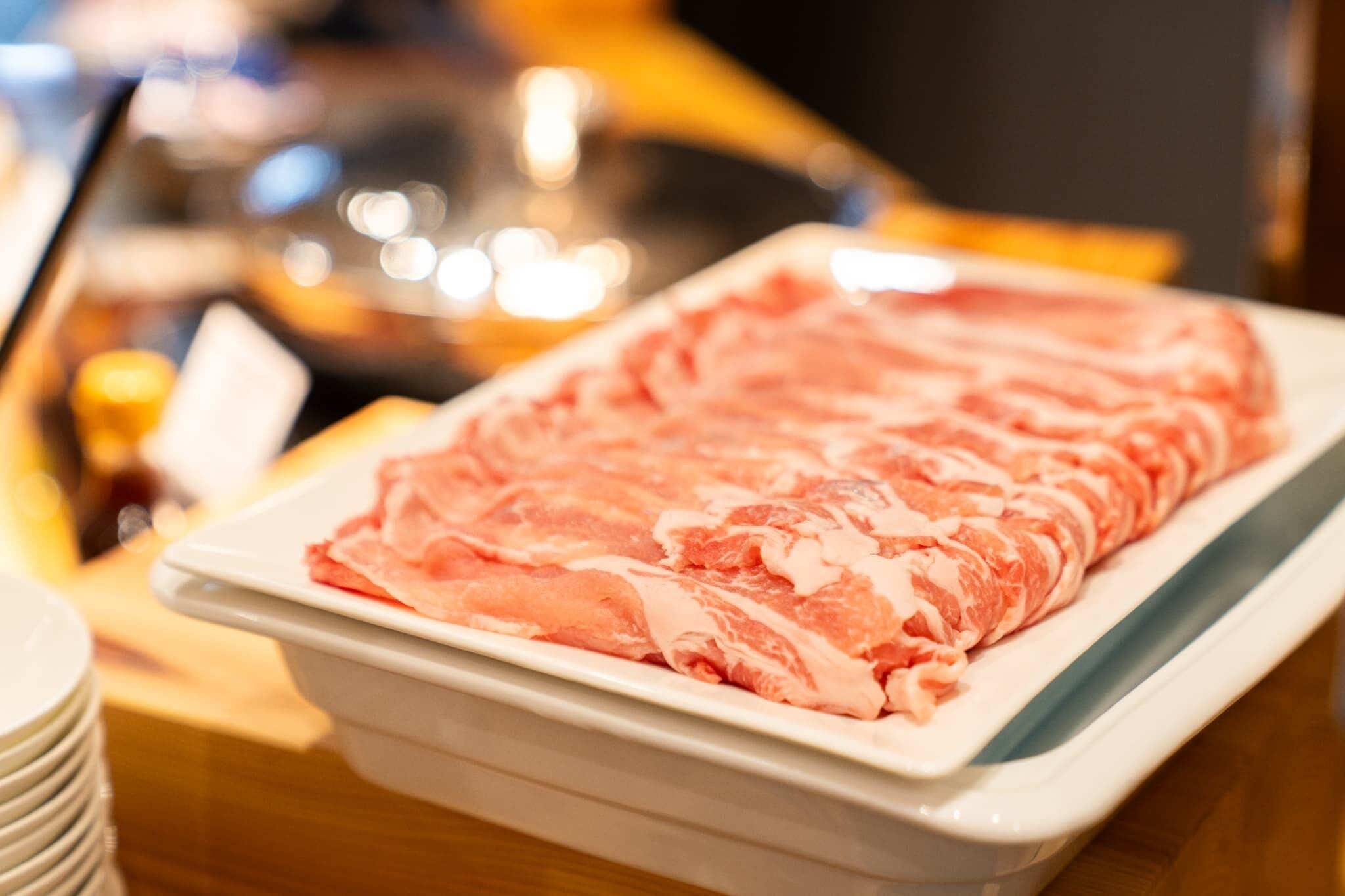 A tray of raw meat on a table.