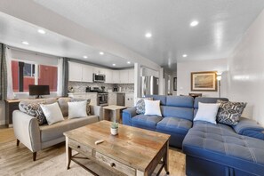 A modern living room with a sofa, a coffee table, and a TV. - Heavenly Condo | Walk to Lift | Balcony | Sleeps 6 (Stateline)