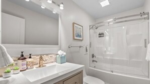 A modern bathroom with a white vanity, a large mirror, a shower with a glass door, and a toilet. - Heavenly Condo | Walk to Lift | Balcony | Sleeps 6 (Stateline)