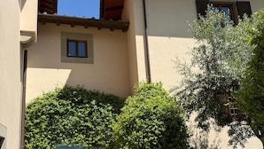 Un edificio con techo de tejas, una ventana pequeña y vistas a un pueblo.