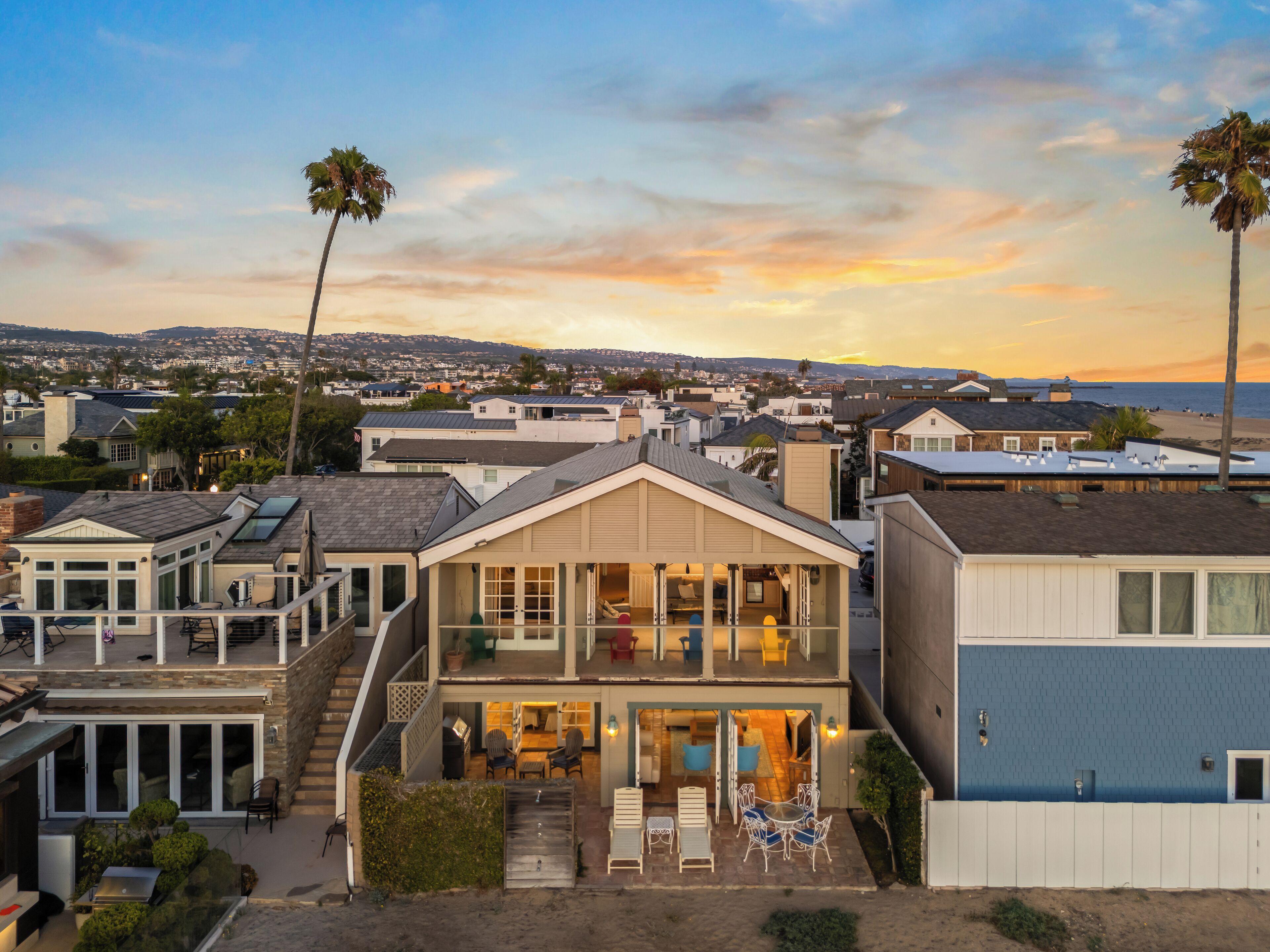 A coastal residential area with houses featuring balconies and a view of the ocean.