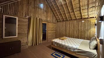 A room with a bed, a window, a wardrobe, and a curtain.
