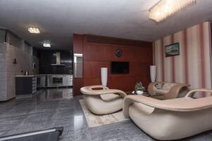 Luxury Apartment, Multiple Beds | Living area | 33-inch LED TV with satellite channels, printers