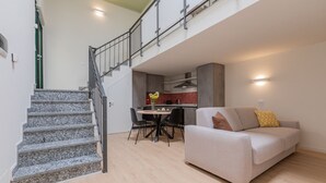 A modern apartment with a staircase, a dining area, and a living room. - Green Loft by Wonderful Italy (Torino)