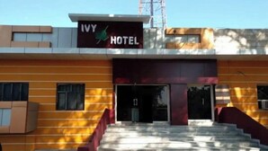 A hotel entrance with a sign reading "IVY HOTEL" and a staircase leading up to the entrance. - lvy Hotel And Restaurant (Mukerian)
