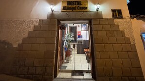 A hostel with a sign reading "HOSTAL El Augui Cusco" at night. - Hostal El Auqui (Cusco)