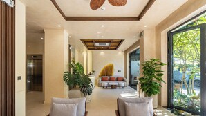A modern hotel lobby with a reception desk, seating area, and large windows. - Sam Hotel & Apartment Da Nang (Da Nang)