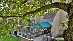 A multi-story building with a green awning labeled "Mountain Green Resort".