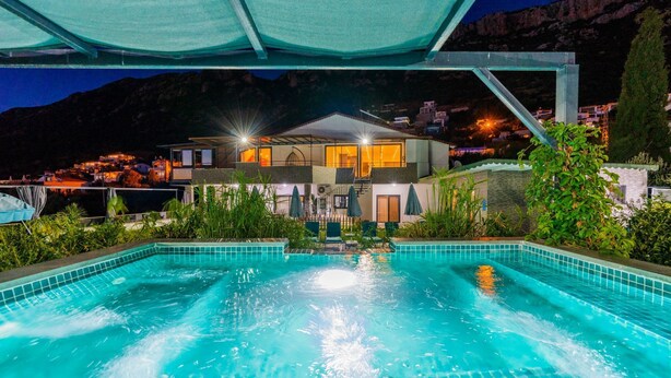 A swimming pool with a view of a two-story building in the background.