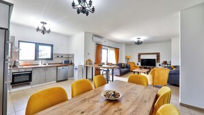 A modern apartment with a kitchen, dining area, and living room.