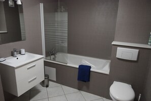 Shower, hair dryer, towels, toilet paper