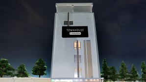 A modern building with a sign reading 'TOWNHOUSE' and a company-serviced logo. - Townhouse Sri Padmavati Ammavaari Temple (Tirupati)