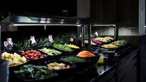 A buffet with various food items including salads, fruits, and vegetables. - Boyalık Beach Palms Hotel (Cesme)