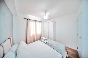 Desk, laptop workspace, blackout drapes, iron/ironing board