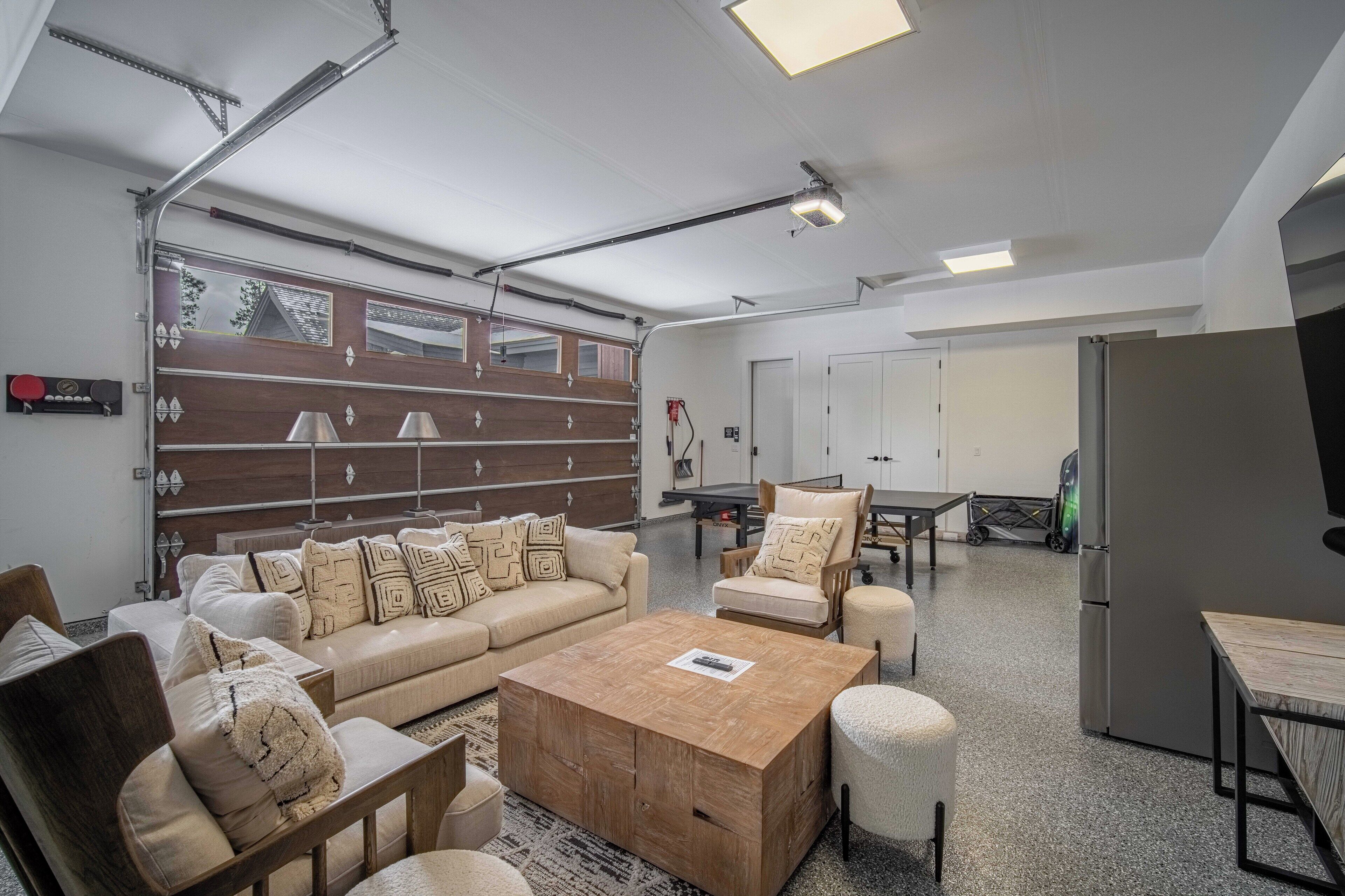 A spacious living area with a sofa set, a wooden coffee table, and a dining table.