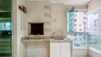 A small kitchen with a window, a sink, and a door.