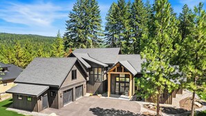 A modern two-story house with a garage, a covered porch, and a driveway leading to the entrance. - Private Pool * Fantastic Outdoor Living in Suncadia! (Cle Elum)