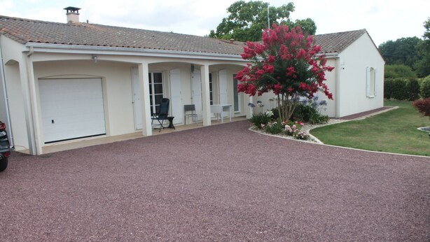 A two-story house with a covered porch, a garage, and a gravel driveway. - Country house (Clam)