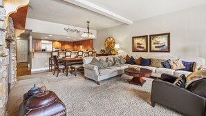 A spacious living room with a sofa, armchairs, and a coffee table. A dining area with chairs and a table is visible in the background. - Spacious Elegance-Kirkwood-Timber Ridge 3 Bedroom 3 Residence (Kirkwood)