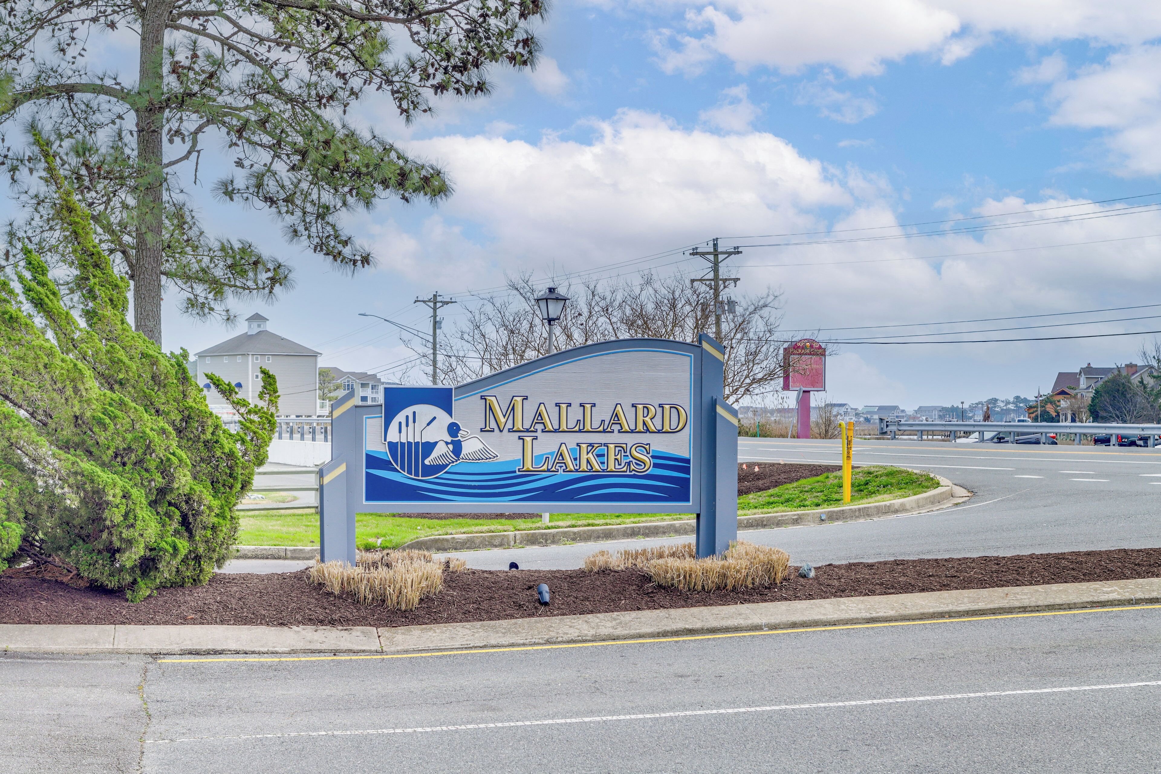 A sign for Mallard Lakes with a water-themed graphic.