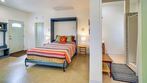 A bedroom with a bed, bedside tables, a ceiling fan, and a door. - Fish, Raft & Hike: Southwest OR Couples Retreat! (Trail)