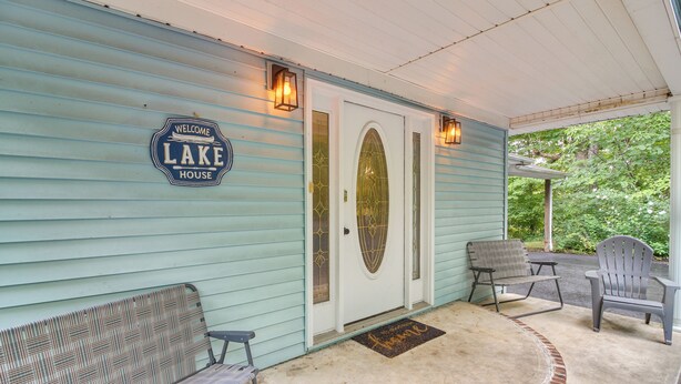 A porch with a bench, two chairs, a welcome sign, and a door with a glass panel. - Family Home w/ Game Room! 1 Mi to Dale Hollow Lake (Burkesville)