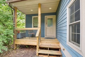 A wooden porch with a bench, a door, and a window. - 1 Mi to Wisp Resort: Hot Tub Haven in Mchenry! (McHenry)