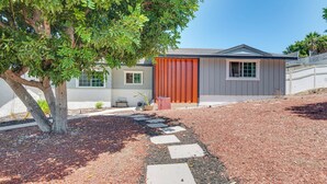 A modern house with a red door, a small window, and a paved driveway leading to the entrance. - Hacienda Heights Gem w/ Large Patio! (Hacienda Heights)