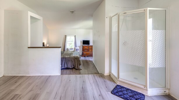 A bedroom with a bed, dresser, and a sliding glass door closet. - 8 Mi to Keuka Lake: Bath Apt w/ Remote-work Perks! (Bath)