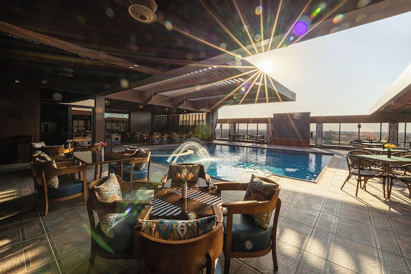 Outdoor pool, open 6:00 AM to 6:00 PM, free pool cabanas, pool umbrellas