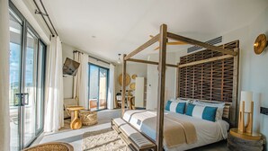 A spacious bedroom with a four-poster bed, a large window, and a view of the outdoors. - 2BR Beachfront Villa | Direct Access | Antigua Views (Urlings)