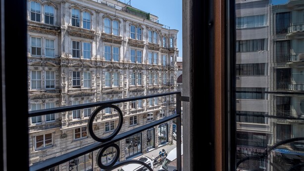 A multi-story building with ornate architectural details, including decorative moldings and large windows.