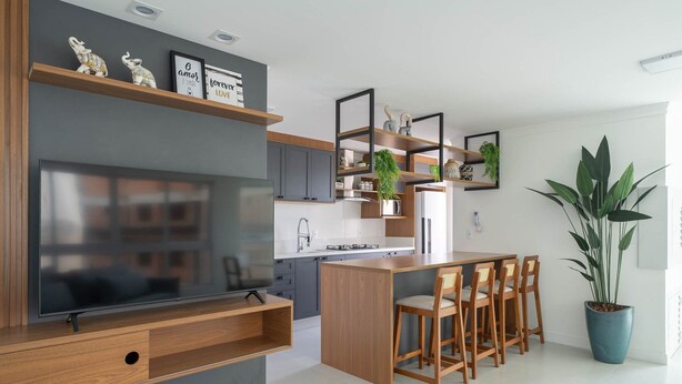 A modern kitchen with a central island, wooden cabinets, and a built-in TV. - 2BR Seaview apt Near Itapema Beach Sem501 (Itapema)