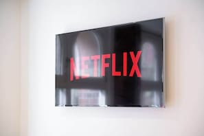 A wall-mounted screen displaying the Netflix logo.