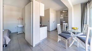 A modern apartment with a kitchen, dining area, and a separate sleeping area. - Country House 'Kate' with Mountain View, Wi-Fi and Air Conditioning (Κερκυρα)