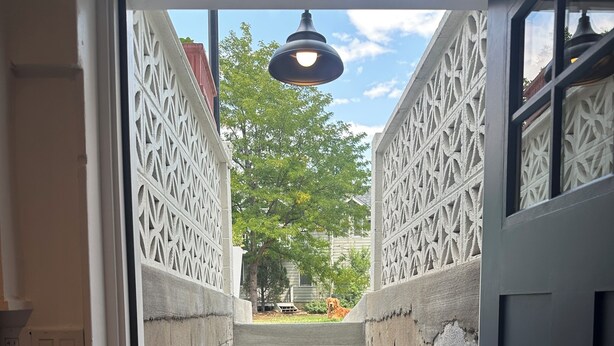 A concrete staircase with a decorative metal railing and a hanging light fixture. - 1BD 1,000sf Private Suite, 2 blocks from Pearl St. (Boulder)