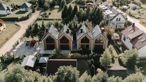 A residential area with multiple houses, including a prominent house with a gabled roof and large windows.