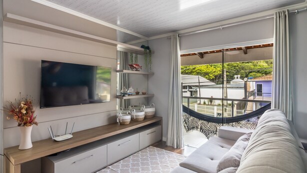 A modern living room with a flat-screen TV, wooden console, and a hammock. - Apt w/ Balcony, 3 Bedrooms Close to Beach Rsu3842 (Penha)