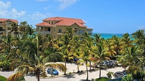 A resort with multiple buildings, a parking area, and a view of the ocean. - The Tides Grace Bay (Providenciales)