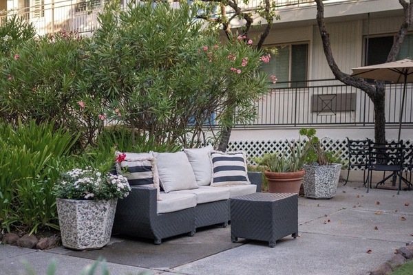 Lounge among blooming planters in a peaceful, private courtyard.