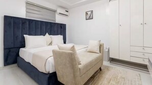 Une chambre moderne équipée d’un lit, d’un canapé, d’un climatiseur et d’une armoire.