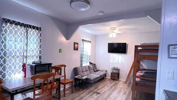 A compact living space with a dining area, sofa, TV, and bunk beds. - Cozy camp on private property minutes from hunting, fishing and restaurants. (Buras)