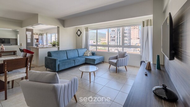 A modern living room with a sofa, armchairs, a coffee table, and a TV. - Charming Apt 550m From Pereque Beach - Rne0301 (Porto Belo)