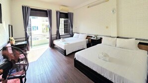 A hotel room with two beds, a ceiling fan, a desk, and a view of the outside. - FOUR SEASONS HOTEL NHA TRANG (Nha Trang)