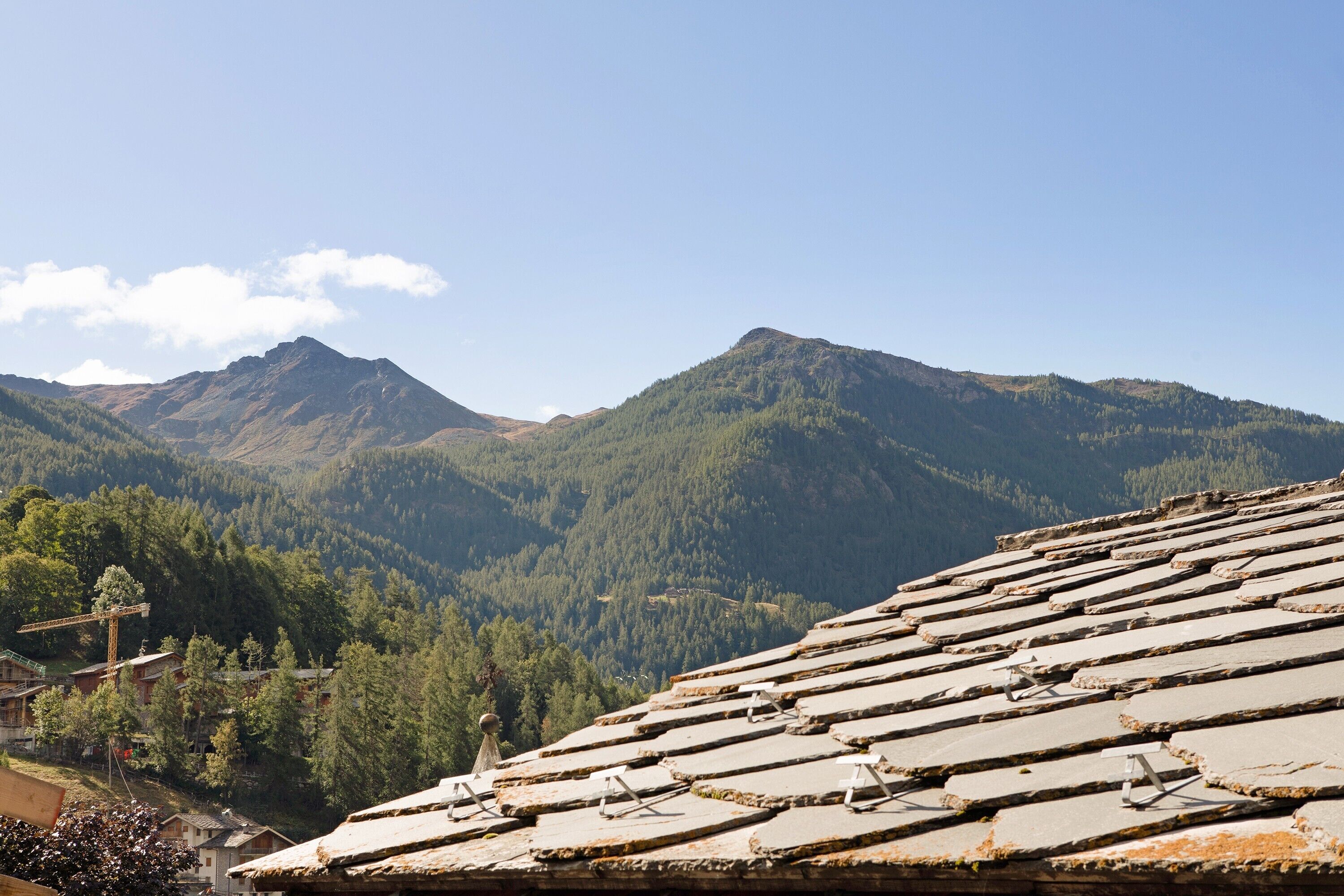 A mountainous landscape with a traditional tiled roof, likely part of a building or structure.