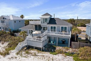 A beachfront property with a two-story house, a covered patio, and a staircase leading to the upper level. - Renovated beachfront retreat within walking distance to three outstanding restaurants! Fall asleep to the sounds of crashing waves on the beautiful Northeast Coast of Florida, just 5 miles from America’s oldest city, St. Augustine! (St. Augustine)
