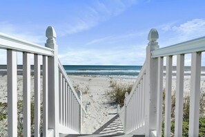 A beach pathway leading to the ocean with a clear sky. - Renovated beachfront retreat within walking distance to three outstanding restaurants! Fall asleep to the sounds of crashing waves on the beautiful Northeast Coast of Florida, just 5 miles from America’s oldest city, St. Augustine! (St. Augustine)