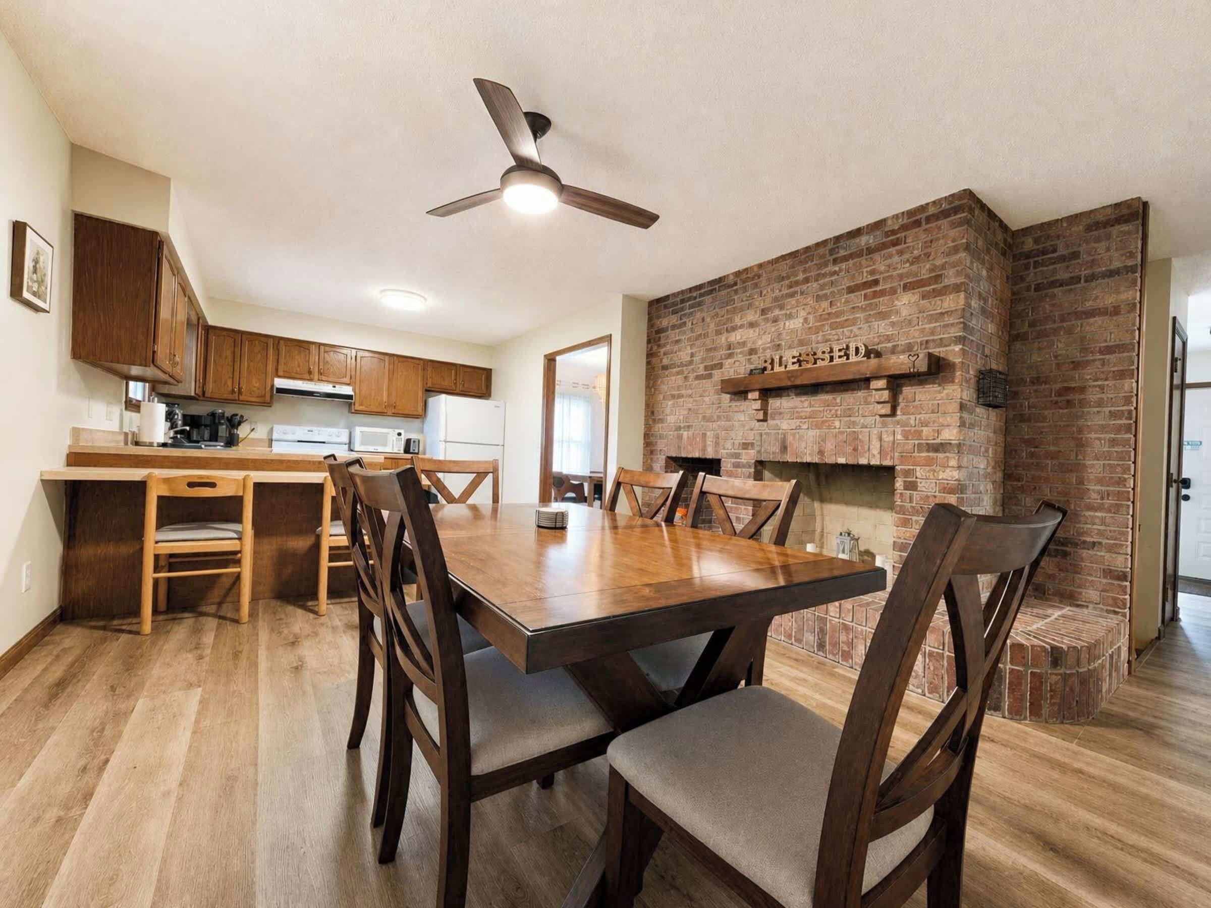Gather with family and friends in this inviting open-concept living and dining area featuring beautiful wood floors, comfortable furnishings, and charming exposed brick accents—a welcoming retreat in Downtown Hamilton.