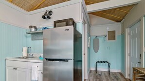 A compact kitchen with a stainless steel refrigerator, a sink, and a small countertop. - Waterfront Coconut Cottage in Fort Myers Beach (Fort Myers Beach)